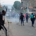 Congolese policemen disperse protesters along the road near the compound of a United Nations peacekeeping force's warehouse in Goma in the North Kivu province of the Democratic Republic of Congo July 26, 2022.