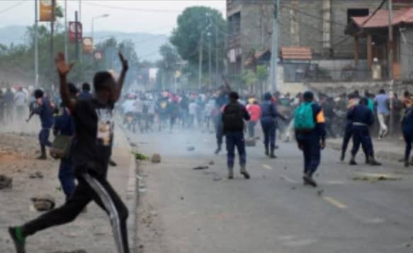 Congolese policemen disperse protesters along the road near the compound of a United Nations peacekeeping force's warehouse in Goma in the North Kivu province of the Democratic Republic of Congo July 26, 2022.