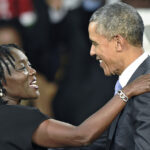 Former US President Barack Obama (R) embraces his sister Auma at the Moi International Sports centre in Nairobi, Kenya,