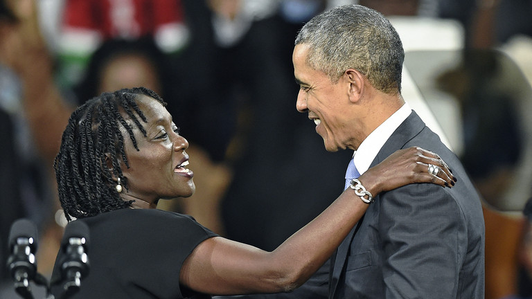 Former US President Barack Obama (R) embraces his sister Auma at the Moi International Sports centre in Nairobi, Kenya,