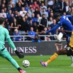 Chelsea’s English midfielder #11 Noni Madueke (2R) shoots to score their fourth goal during the English Premier League football match between Wolverhampton Wanderers and Chelsea at the Molineux stadium in Wolverhampton, central England on August 25, 2024. (Photo by JUSTIN TALLIS / AFP)