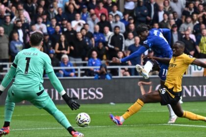 Chelsea’s English midfielder #11 Noni Madueke (2R) shoots to score their fourth goal during the English Premier League football match between Wolverhampton Wanderers and Chelsea at the Molineux stadium in Wolverhampton, central England on August 25, 2024. (Photo by JUSTIN TALLIS / AFP)