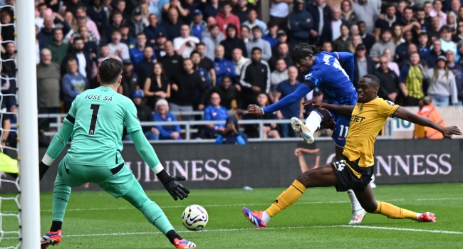 Chelsea’s English midfielder #11 Noni Madueke (2R) shoots to score their fourth goal during the English Premier League football match between Wolverhampton Wanderers and Chelsea at the Molineux stadium in Wolverhampton, central England on August 25, 2024. (Photo by JUSTIN TALLIS / AFP)