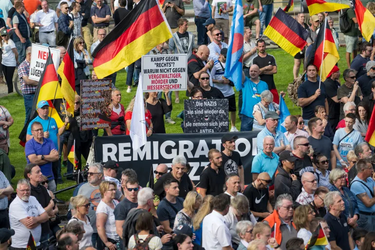 Supporters of the far-right and anti-immigration Alternative for Germany party gather a week after the murder of a police officer by an Afghan immigrant, in Mannheim, Germany [File: Thomas Lohnes/Getty]