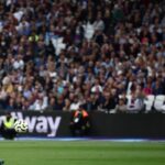 Manchester City’s Norwegian striker Erling Haaland (L) scores his third goal past West Ham United’s Polish goalkeeper Lukasz Fabianski at the London Stadium, in London on August 31, 2024. (Photo by HENRY NICHOLLS / AFP)