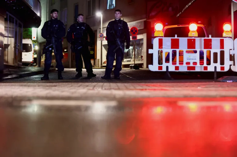 Police officers secure the area of an incident after three people were killed on Friday when a man randomly stabbed passers-by with a knife at a festival in Solingen, Germany [Thilo Schmuelgen/Reuters]