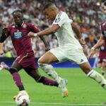 TOPSHOT – Real Madrid’s French forward #09 Kylian Mbappe (2R) is challenged by Real Valladolid’s French defender #06 Flavien Boyomo (2L) during the Spanish league football match between Real Madrid CF and Real Valladolid FC at the Santiago Bernabeu stadium in Madrid on August 25, 2024. (Photo by Pierre-Philippe MARCOU / AFP)