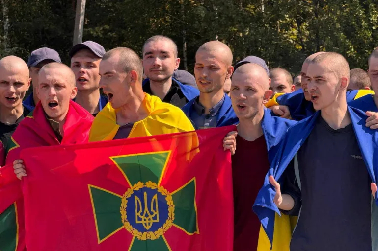 Freed Ukrainian prisoners of war at an unknown location in Ukraine, on August 24 [Handout/Ukraine's President Volodymyr Zelenskyy via Reuters]