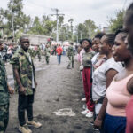 Female volunteers wanting to join the Congolese army stand near a military base in Goma in 2022 [File: Alexis Huguet/AFP]