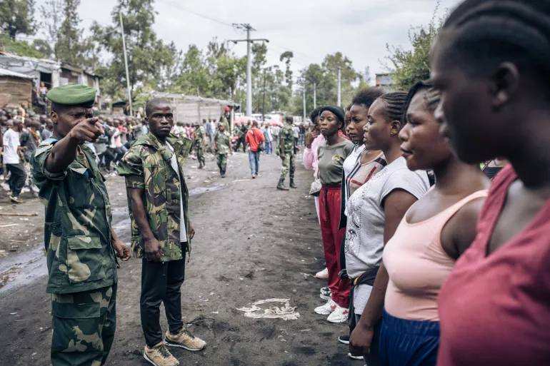 Female volunteers wanting to join the Congolese army stand near a military base in Goma in 2022 [File: Alexis Huguet/AFP]