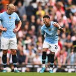 Erling Haaland looks at Manchester City’s Brazilian midfielder #26 Savinho (R) reacting due an injury during the match between Manchester City and Brentford at the Etihad Stadium in Manchester, north west England, on September 14, 2024. (Photo by Oli SCARFF / AFP)