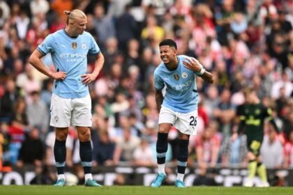 Erling Haaland looks at Manchester City’s Brazilian midfielder #26 Savinho (R) reacting due an injury during the match between Manchester City and Brentford at the Etihad Stadium in Manchester, north west England, on September 14, 2024. (Photo by Oli SCARFF / AFP)