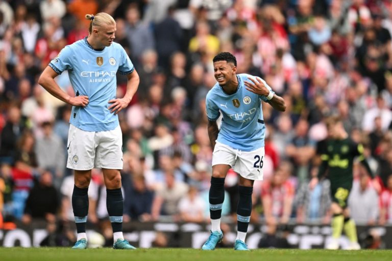 Erling Haaland looks at Manchester City’s Brazilian midfielder #26 Savinho (R) reacting due an injury during the match between Manchester City and Brentford at the Etihad Stadium in Manchester, north west England, on September 14, 2024. (Photo by Oli SCARFF / AFP)