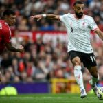 Liverpool’s Egyptian striker #11 Mohamed Salah crosses the ball during the English Premier League football match between Manchester United and Liverpool at Old Trafford in Manchester, north west England, on September 1, 2024. (Photo by Paul ELLIS / AFP)