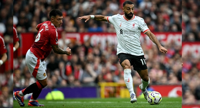 Liverpool’s Egyptian striker #11 Mohamed Salah crosses the ball during the English Premier League football match between Manchester United and Liverpool at Old Trafford in Manchester, north west England, on September 1, 2024. (Photo by Paul ELLIS / AFP)