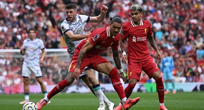 Liverpool’s Uruguayan striker #09 Darwin Nunez and Liverpool’s Colombian midfielder #07 Luis Diaz challenge Bournemouth’s Scottish midfielder #10 Ryan Christie (back L) during the English Premier League football match between Liverpool and Bournemouth at Anfield in Liverpool, northwest England, on September 21, 2024. (Photo by Paul ELLIS / AFP)