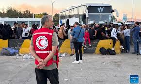 People gather at the Jdeidat Yabous border crossing in the countryside of Damascus, Syria, Sept. 25, 2024. Thousands of Lebanese and Syrian families fled Lebanon for Syria as Israeli airstrikes continued, said the Office of the United Nations High Commissioner for Refugees (UNHCR) on Wednesday. (Photo: Xinhua)