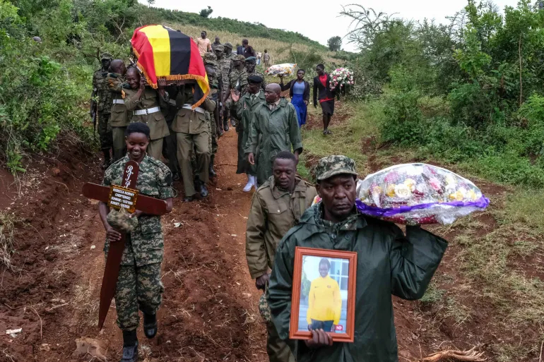 Members of the Uganda Peoples' Defence Forces carry the coffin of Olympic athlete Rebecca Cheptegei before her burial in Bukwo, Uganda [Hajarah Nalwadda/AP]