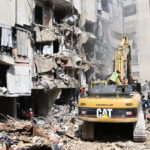 Workers use heavy construction equipment to remove debris from the site of an Israeli airstrike in Beirut, Lebanon, September 21, 2024 © Getty Images / Houssam Shbaro