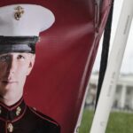 FILE PHOTO: A banner showing the military service photo of Trevor Reed. © Anna Moneymaker / Getty Images