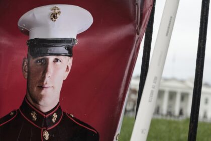 FILE PHOTO: A banner showing the military service photo of Trevor Reed. © Anna Moneymaker / Getty Images