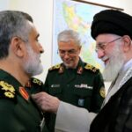 TOPSHOT – A handout picture provided by the office of Iran’s Supreme Leader Ayatollah Ali Khamenei on October 6, 2024 shows him (R)decorating the Islamic Revolutionary Guard Corps’ Aerospace Force Commander Brigadier General Amir Ali Hajizadeh (L) with the ‘Fath’ badge in Tehran for plannig the Iranian attack on Israel. (Photo by KHAMENEI.IR / AFP)