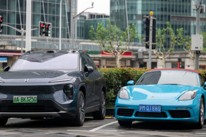 An electric car from the Chinese brand NIO and one from Porsche with a combustion engine are pictured during a visit by German Economy Minister Robert Habeck to China in June 2024. © Sebastian Christoph Gollnow/picture alliance via Getty Images