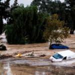 Cars swept away by water after floods preceded by heavy rains caused the river to overflow its banks in the town of Alora, Malaga [Gregorio Marrero/AP Photo]