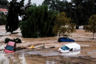 Cars swept away by water after floods preceded by heavy rains caused the river to overflow its banks in the town of Alora, Malaga [Gregorio Marrero/AP Photo]