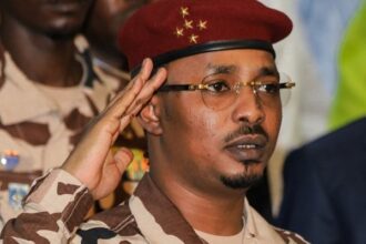 FILES) Chad’s junta leader Mahamat Idriss Deby Itno salutes during the closing ceremony of the National Sovereign Inclusive Dialogue (DNIS) forum, in N’Djamena on October 8, 2022. (Photo by Denis Sassou Gueipeur / AFP)