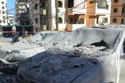 Damaged cars lie in a cordoned-off area hit in an Israeli airstrike that targeted an apartment building in the Palestinian refugees camp of Al-Baddawi near the northern Lebanese city of Tripoli on October 5, 2024. – Palestinian militant group Hamas said an Israeli strike killed one of its commanders, Saeed Attallah Ali, his wife and two daughters, in the refugee camp on October 5, the first time the area had been hit since the start of the Gaza war. (Photo by FATHI AL MASRI / AFP)