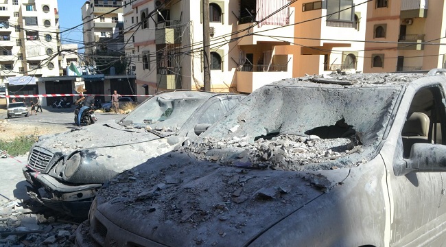 Damaged cars lie in a cordoned-off area hit in an Israeli airstrike that targeted an apartment building in the Palestinian refugees camp of Al-Baddawi near the northern Lebanese city of Tripoli on October 5, 2024. – Palestinian militant group Hamas said an Israeli strike killed one of its commanders, Saeed Attallah Ali, his wife and two daughters, in the refugee camp on October 5, the first time the area had been hit since the start of the Gaza war. (Photo by FATHI AL MASRI / AFP)