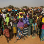 Displaced people wait for help at a village in Dablo area, Burkina Faso [File: Luc Gnago/Reuters]