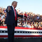 Donald Trump gestures as he walks onstage for a campaign rally in Coachella, California, October 12, 2024 © Getty Images / Mario Tama