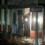 Person walks through surge waters after Hurricane Milton made landfall in Fort Myers, Florida © Getty Images / Joe Raedle