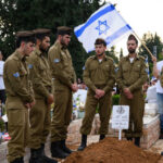 Israeli soldiers stand guard around the grave of a comrade killed in Lebanon, during his funeral near Tel Aviv, Israel, October 6, 2024 © Getty Images / Leon Neal