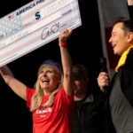 Musk awarded Kristine Fishell with a $1 million check during the town hall at the Roxain Theater on October 20, 2024 in Pittsburgh, Pennsylvania © Michael Swensen/Getty Images