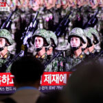 People watch a North Korean military parade on a TV in Seoul, South Korea, October 10, 2020 © Getty Images / Chung Sung-Jun