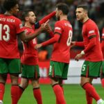 (L-R= Portugal’s midfielder #13 Renato Veiga, Portugal’s midfielder #10 Bernardo Silva, Portugal’s midfielder #08 Bruno Fernandes, Portugal’s defender #05 Diogo Dalot and Portugal’s defender #19 Nuno Mendes celebrate the 1-3 goal during the UEFA Nations League, League A Group A1 football match Poland vs Portugal at the National Stadium in Warsaw, Poland on October 12, 2024. (Photo by Sergei GAPON / AFP)