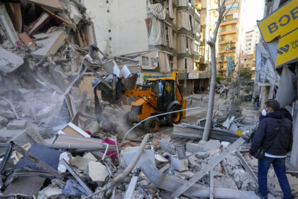 Rescue workers use a bulldozer to remove rubble of destroyed buildings at the site of an Israeli airstrike in Beirut's southern suburb, Lebanon, October 21, 2024 © AP / Hassan Ammar