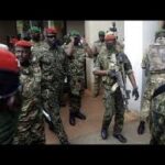 Guinea's Junta President Col. Mamady Doumbouya, centre, is heavily guarded by soldiers after a meeting with ECOWAS delegation in Conakry, Guinea Friday, Sept. 10, 2021.