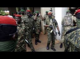 Guinea's Junta President Col. Mamady Doumbouya, centre, is heavily guarded by soldiers after a meeting with ECOWAS delegation in Conakry, Guinea Friday, Sept. 10, 2021.