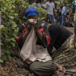 Women weep in the port of Goma, DRC, after a ferry carrying hundreds of people capsized