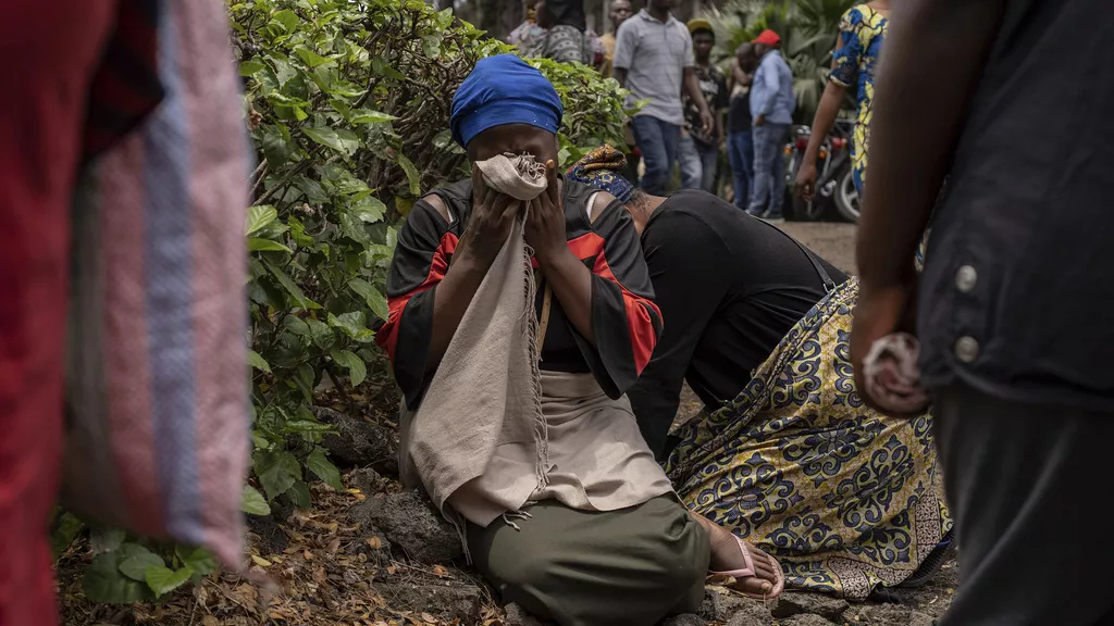 Women weep in the port of Goma, DRC, after a ferry carrying hundreds of people capsized