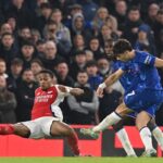 Chelsea’s Portuguese midfielder #07 Pedro Neto (R) shoots to score their first goal during the English Premier League football match between Chelsea and Arsenal at Stamford Bridge in London on November 10, 2024. (Photo by Glyn KIRK / AFP) /