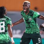 Nigeria’s forward #18 Ademola Lookman (L) celebrates scoring his team’s first goal with Nigeria’s forward #9 Victor Osimhen during the Africa Cup of Nations 2023 round of 16 football match between Nigeria and Cameroon at the Felix Houphouet-Boigny Stadium in Abidjan on January 27, 2024. (Photo by FRANCK FIFE / AFP)