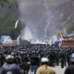 Police officers advance towards supporters of former President Evo Morales, who are blocking a road near Parotani, Bolivia on November 1, 2024. © Pablo Rivera / Anadolu / Getty Images