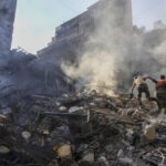 FILE PHOTO. Rescue workers search for victims at the site of Thursday's Israeli airstrike in Beirut, Lebanon. © AP Photo/Hassan Ammar