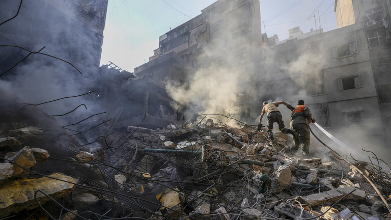 FILE PHOTO. Rescue workers search for victims at the site of Thursday's Israeli airstrike in Beirut, Lebanon. © AP Photo/Hassan Ammar