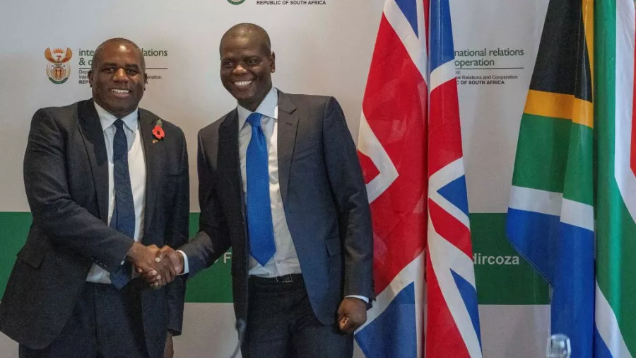 David Lammy and Ronald Lamola shake hands before the start of their meeting in Cape Town, South Africa.